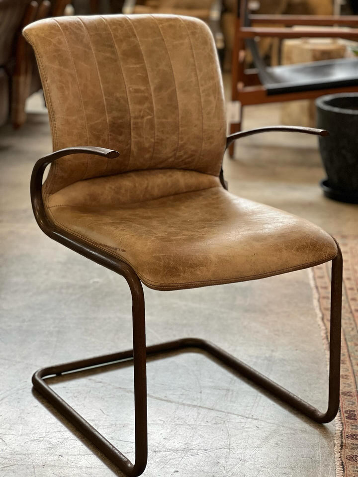 Chic vintage chair featuring genuine leather and a sturdy steel frame